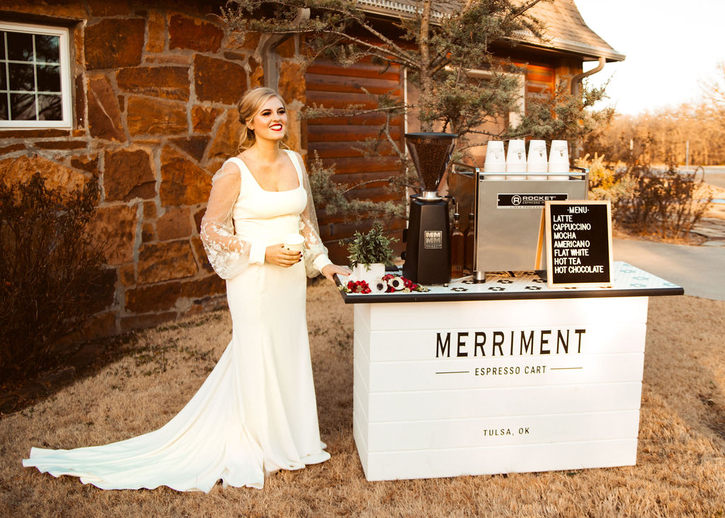 bride posing with a coffee cart at a premium wedding